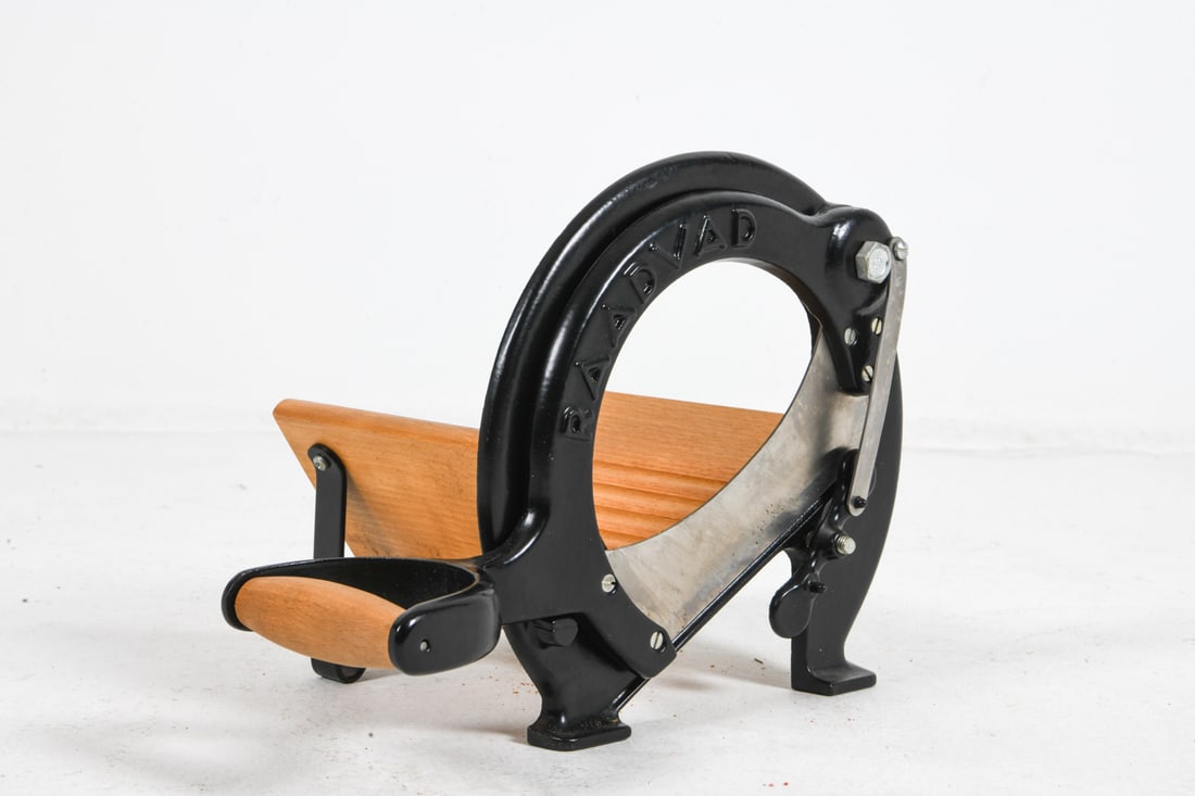 RAADVAD DANISH BREAD SLICER: Marked to wooden plate. Denmark. Dimensions: H 9.5" x W 9.26" x D 13.75". Condition: Wear consistent with age and use.
