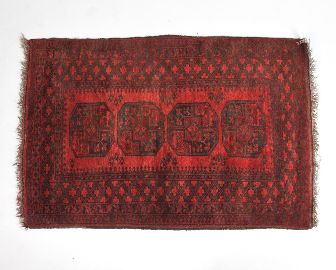 20TH CENTURY AFGHAN ORIENTAL RUG: Hand-knotted oriental rug with octagonal 'gol' patterns. 20th century. Dimensions: L 72" x W 47". Condition: Minor losses to fringe. Some fading, overall presents well.