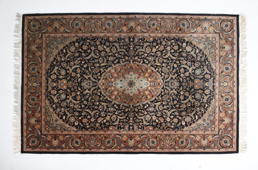 ORIENTAL RUG: Hand-knotted oriental rug with floral geometric design. 20th century. Dimensions: L 92" x W 55". Condition: Overall presents well, light sun fading throughout.