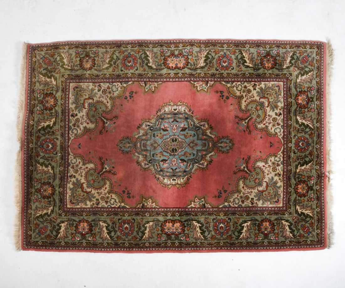 TURKISH ORIENTAL RUG: Hand-knotted wool right with pink, green, and beige medallion design. 20th century. Dimensions : L 98" x W 70". Condition: Loss to fringe, Fading, Wear consistent with age and use.