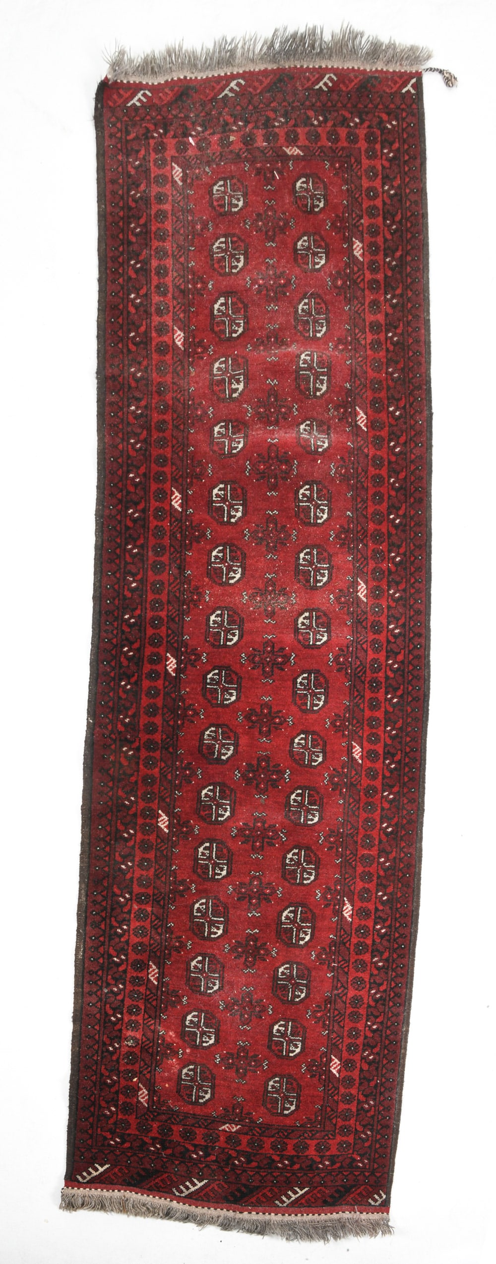 AFGHAN ORIENTAL RUNNER RUG: Hand-knotted wool rug with geometric pattern. 20th century. Dimensions: L 107" x W 33". Condition: Minor losses to border, overall presents well. Some losses to pile.