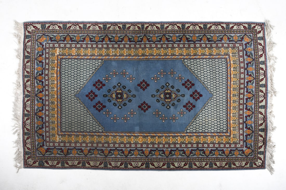 ORIENTAL RUG: Hand-knotted wool oriental rug in beige and grey tones. 20th century. Dimensions: L 102" x W 58". Condition: Overall presents well. Minor losses to border.