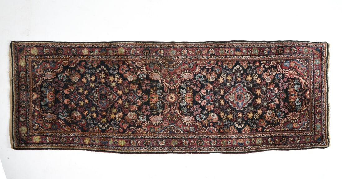 PERSIAN ORIENTAL RUNNER RUG: Hand-knotted wool rug in multicolored floral design. 20th century. Dimensions: L 118" x W 41.5". Condition: Losses to border and fringe. slight discoloration to fringe and pile.