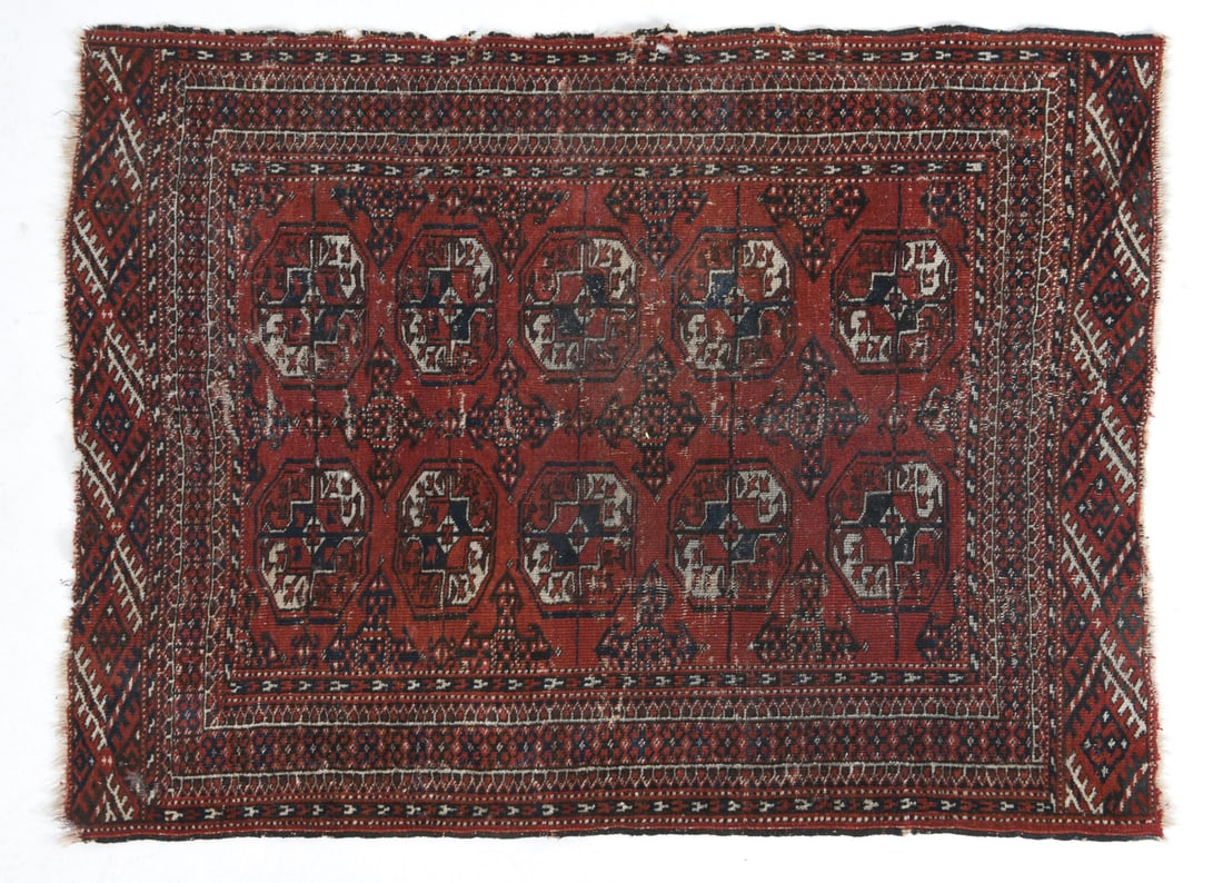 TURKISH ORIENTAL RUG: Hand-knotted wool rug with red and black geometric patterns. Dimensions: L 55" x W 40.5". Condition: Minor Fading. Wear consistent with age and use.