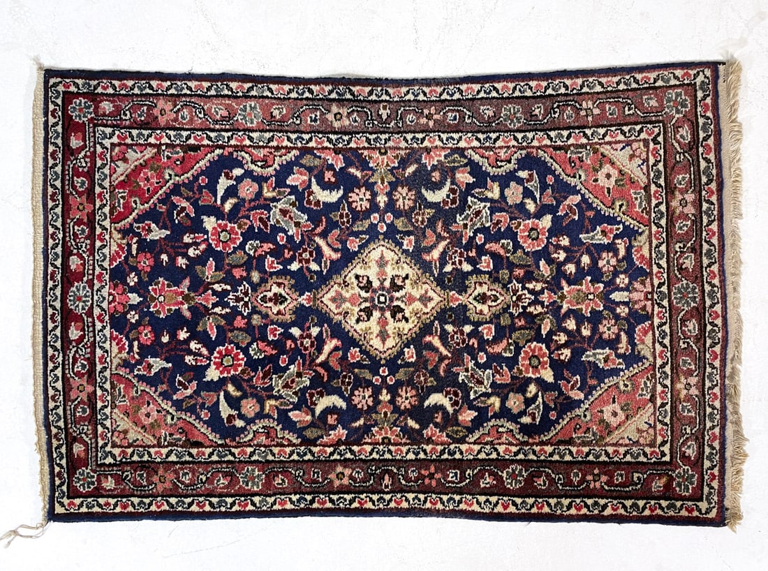 PERSIAN ORIENTAL RUG: Hand-knotted wool rug in navy and beige geometric design. 20th century. Dimensions: H 50" x W 32". Condition: Wear consistent with age and use, minor losses to fringe.