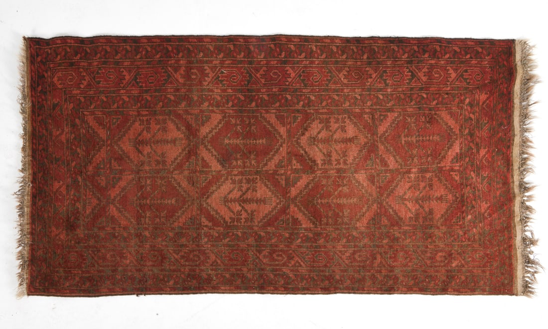 AFGHAN BALUCH ORIENTAL RUG: Hand-knotted wool rug with red and orange geometric designs. 20th century. Dimensions: W 84" x D 44" . Condition: Some fading and losses to fringe. Wear consistent with age and use.