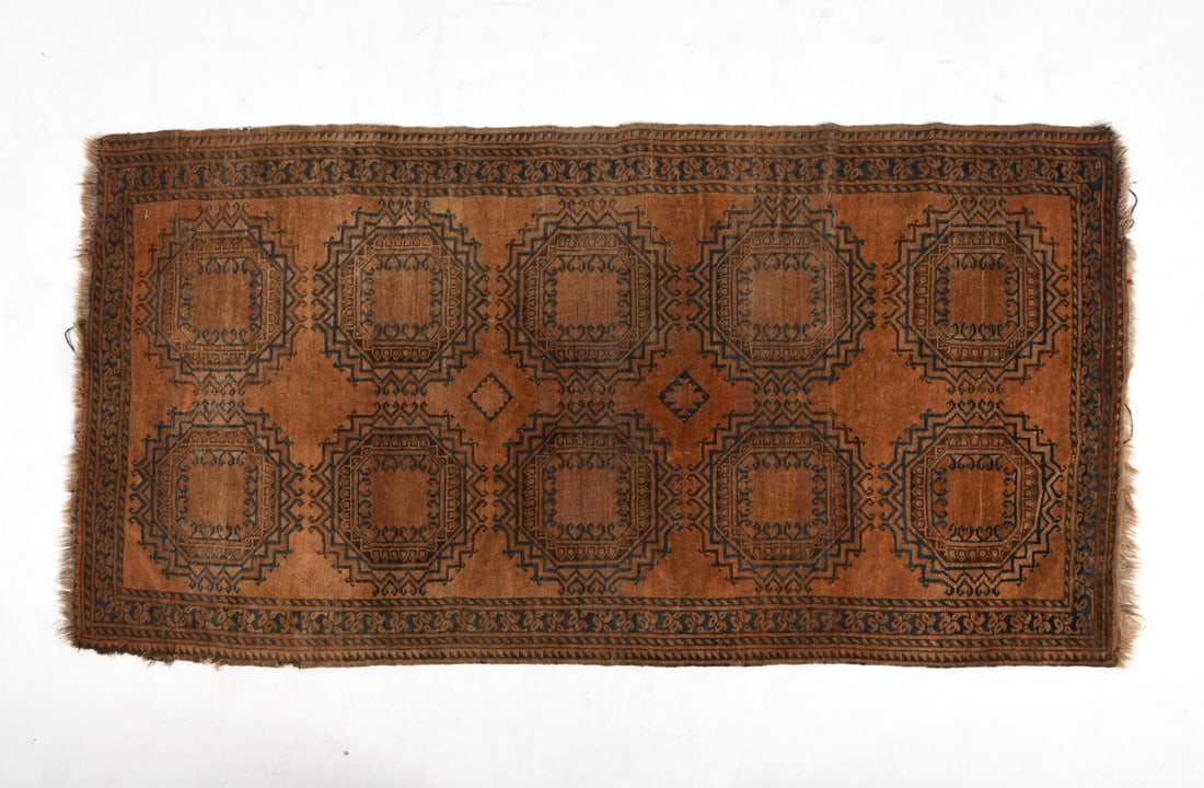 ORIENTAL RUG: Hand-knotted oriental rug with geometric pattern. Mid 20th century. Dimensions: L 84" x W 43". Condition: Losses to border and fringe. Heavy sun fading and losses to pile. Wear consistent with age