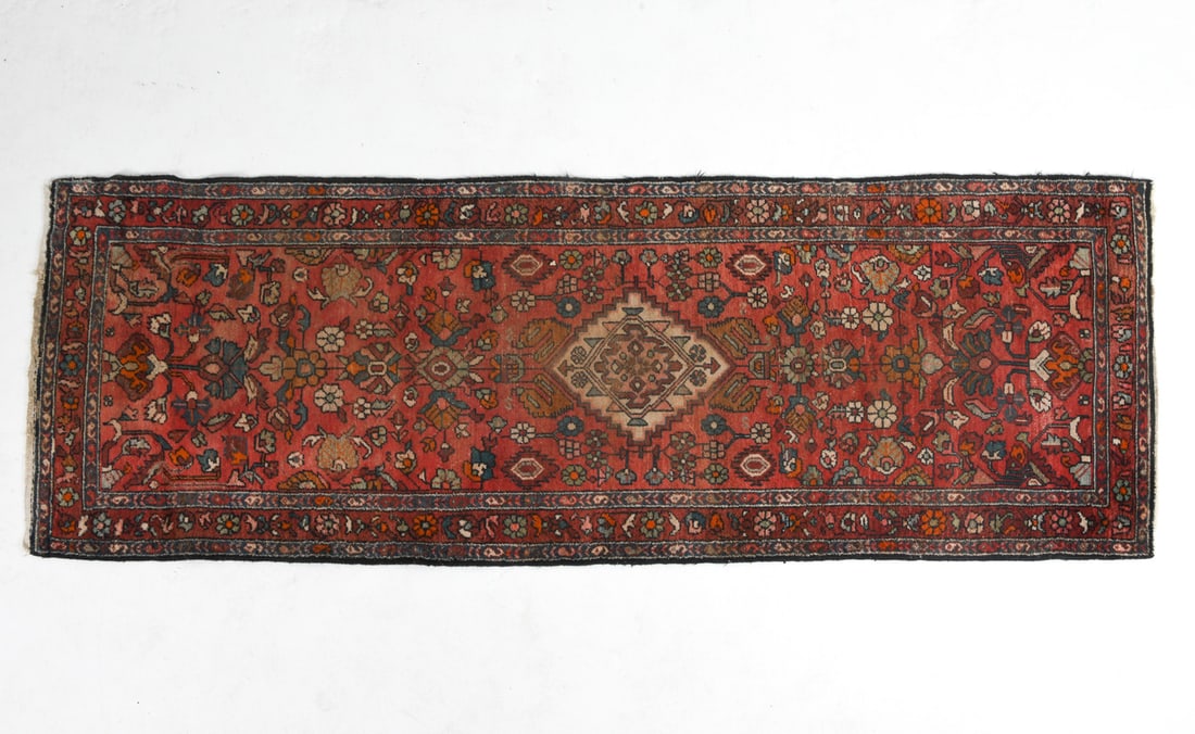 HAMEDAN ORIENTAL RUNNER RUG: Hand-knotted wool rug with colorful floral and geometric designs. 20th century. Dimensions: L 112" x W 39". Condition: Losses to fringe, Sun fading, Wear consistent with age and use.