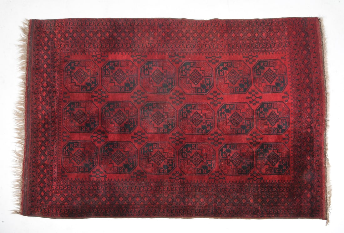 AFGHAN ORIENTAL RUG: Hand-knotted wool rug with octagonal elephant footsteps or 'gul' pattern. 20th century. Dimensions: H 122" x W 82.5". Condition: Wear consistent with age and use including minor sun-fading.