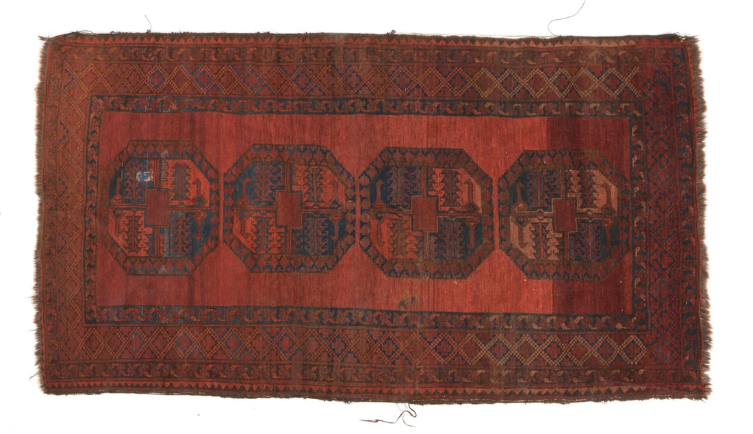 ORIENTAL RUG: Hand-knotted red oriental rug with geometric design. 20th century. Dimensions: L 92" x W 51". Condition: Losses to fringe and border. Minor discoloration/fading to pile. Needs cleaning.