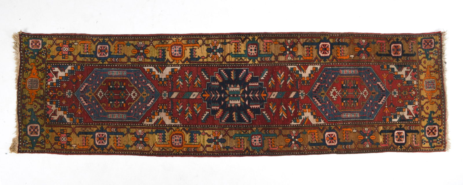 PERSIAN HERIZ ORIENTAL RUG: Hand-knotted wool rug with red, blue, and cream geometric designs. 20th century. Dimensions: L 126.5" x W 37". Condition: With some losses to fringe. Cleaning recommended.