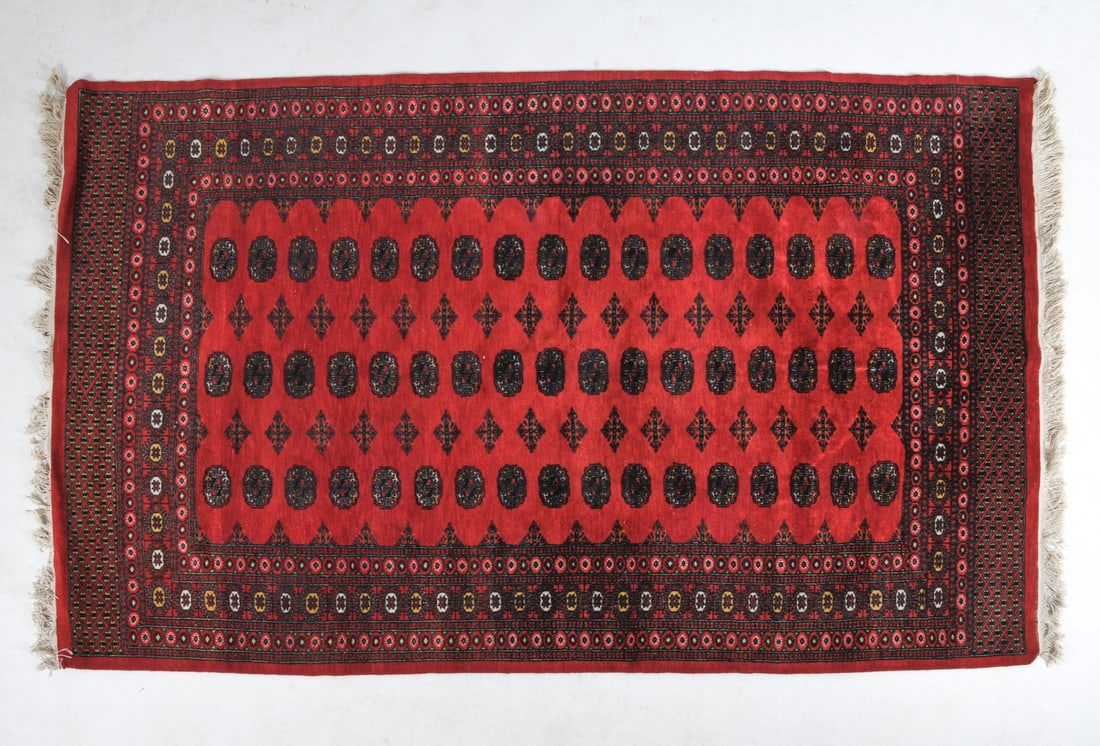 AFGHAN ORIENTAL RUG: Hand-knotted wool rug with elephant foot or 'gul' pattern. 20th century. Dimensions: L 109" x W 64". Condition: Showing signs of wear including light fraying, small areas of fringe loss and light