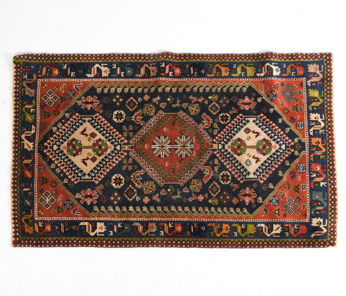 BAKHTIARI ORIENTAL RUG: Hand-knotted wool rug with multicolored geometric designs. 20th century. Dimensions: L 64" x W 38.5". Condition: Wear consistent with age and use.