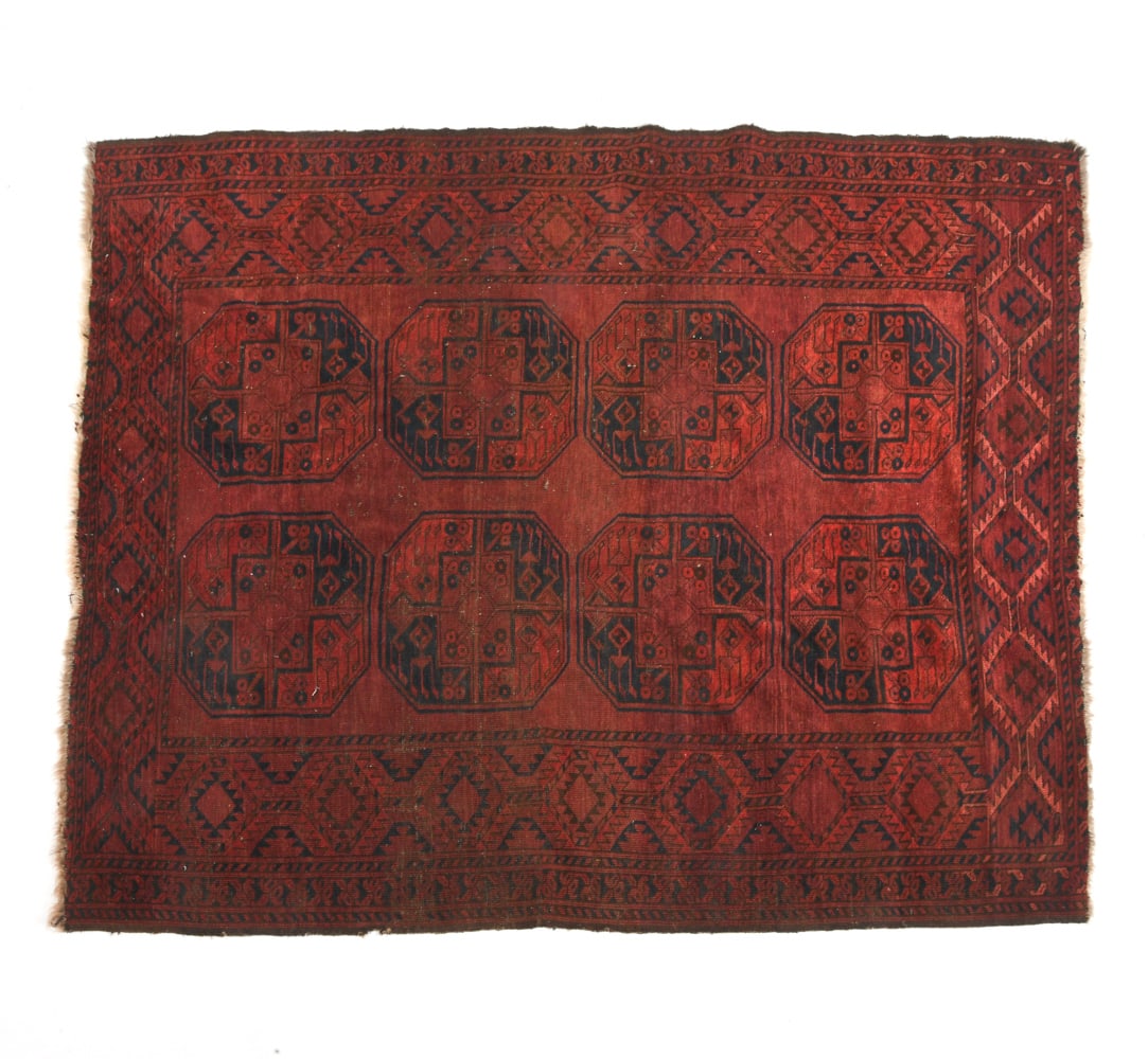 AFGHAN ORIENTAL RUG: Hand-knotted wool rug with repeating elephant footsteps or 'gul' pattern. 20th century. Dimensions : L 78" x W 66". Condition: Fading, loss to fringe. Wear consistent with age and use.