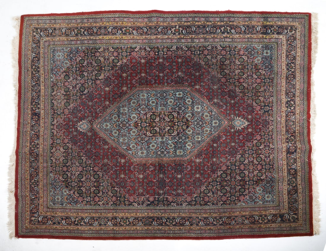 INDO BIDJAR DESIGN ORIENTAL RUG: Hand-knotted wool rug with red, black, and beige geometric designs. 20th century. Dimensions : L 122" x W 98". Condition: Fading, Loss to fringe. Wear consistent with age and use.