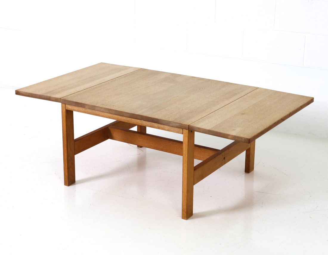 STYLE OF MOGENSEN OAK EXTENDING COFFEE TABLE 1960S: Two drop-down leave. Oak frame. Denmark, circa 1960s. Dimensions: H 18.5" x W 31.25" x D 29" Condition: Wear consistent with age and use.