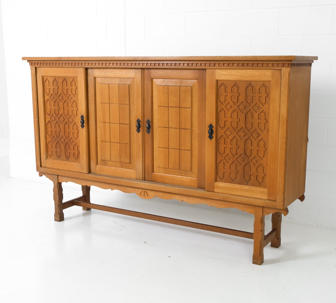 ATTR. HENNING KJAERNULF DANISH OAK SIDEBOARD: Geometric patterns on sliding doors. Six felt-lined drawers inside. Apparently unmarked. Denmark, circa 1970s. Dimensions: H 49.5" x W 81" x D 18.5" Condition: Faint water rings to top and shelves,
