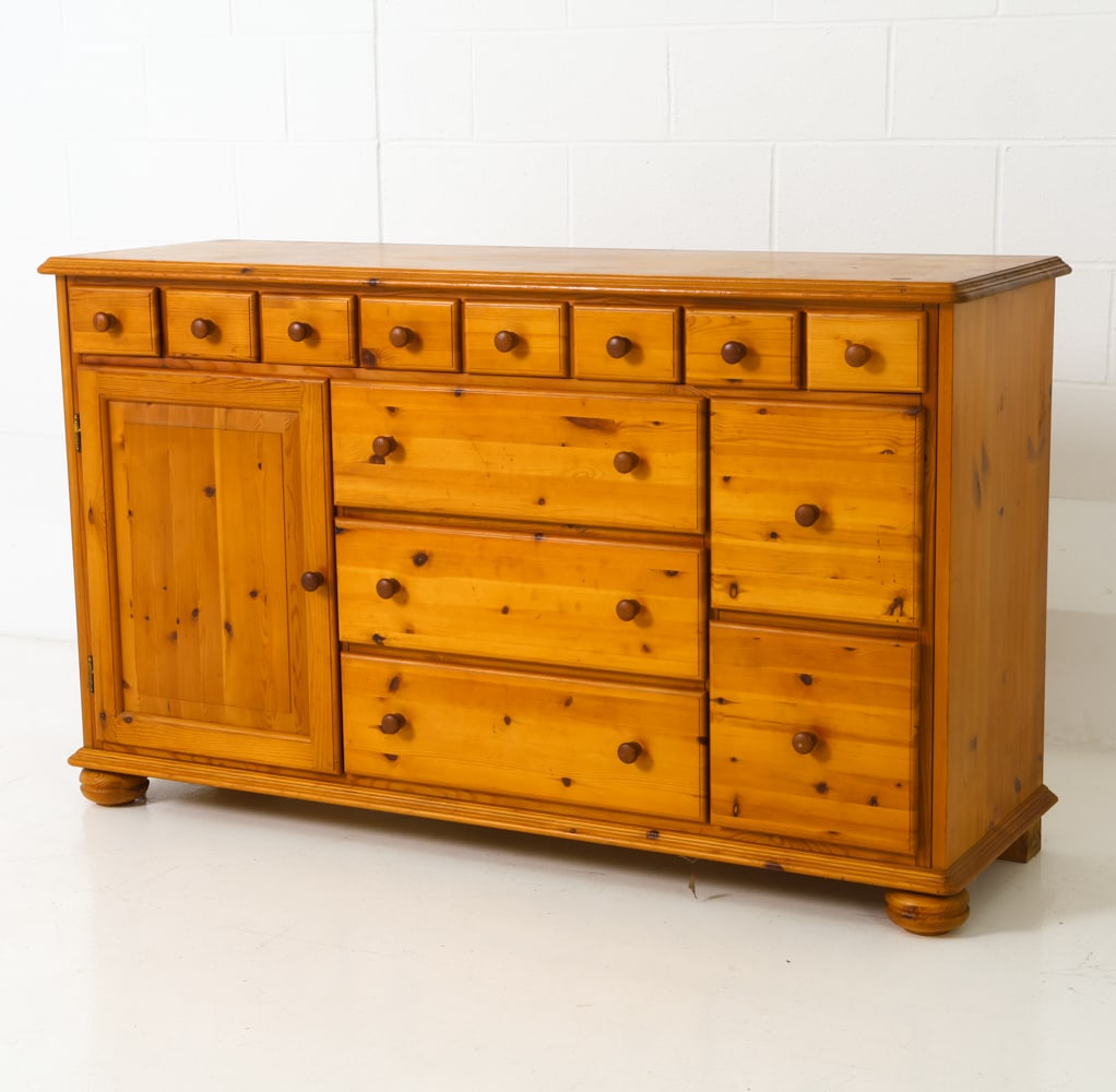 TASINGE DANISH PINE SIDEBOARD CHEST: Pine chest featuring many drawers, smaller, medium and large and one cabinet door with a single shelf inside. Stamped on back panel, made in Denmark, Tasinge Maskinsnedkeri ApS. Dimensions: H 34.5" x