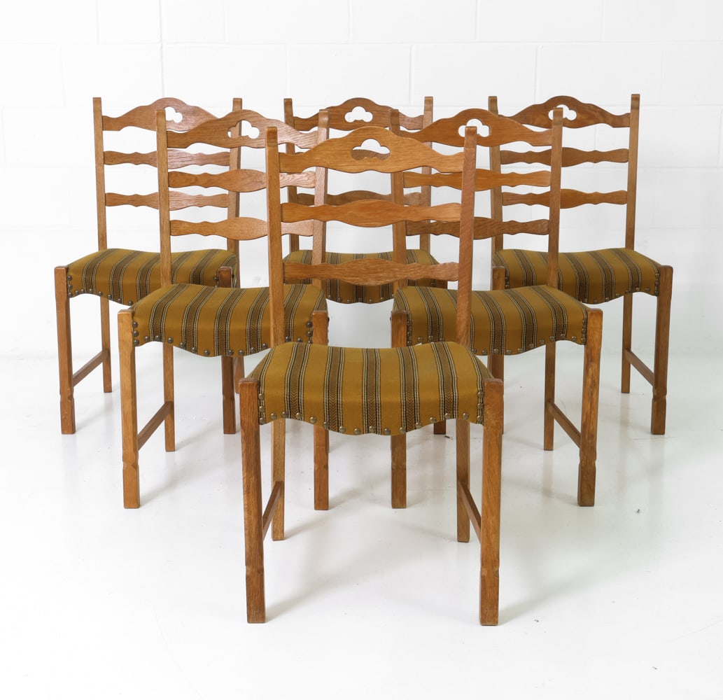(6) STYLE OF KJAERNULF DANISH OAK DINING CHAIRS: Oak frame with sculptural backrest design. Striped upholstery and brass nails details. Denmark, circa 1960s. Dimensions: H 34.5" x W 18.5" x D 19" x Sh 17.5" Conditions: Rubs and scratches to backrest