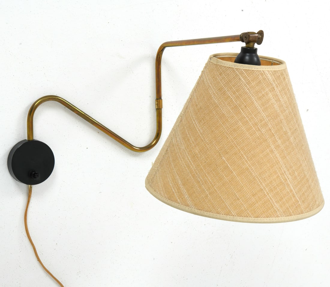 DANISH BRASS SWING ARM WALL SCONCE CIRCA 1950'S: Conical raffia shade and brass arm. Denmark, circa 1950's. Dimensions: H 11" x W 10" x D 17.75" Conditions: Not tested, the cord is cut. Wear consistent with age and use.