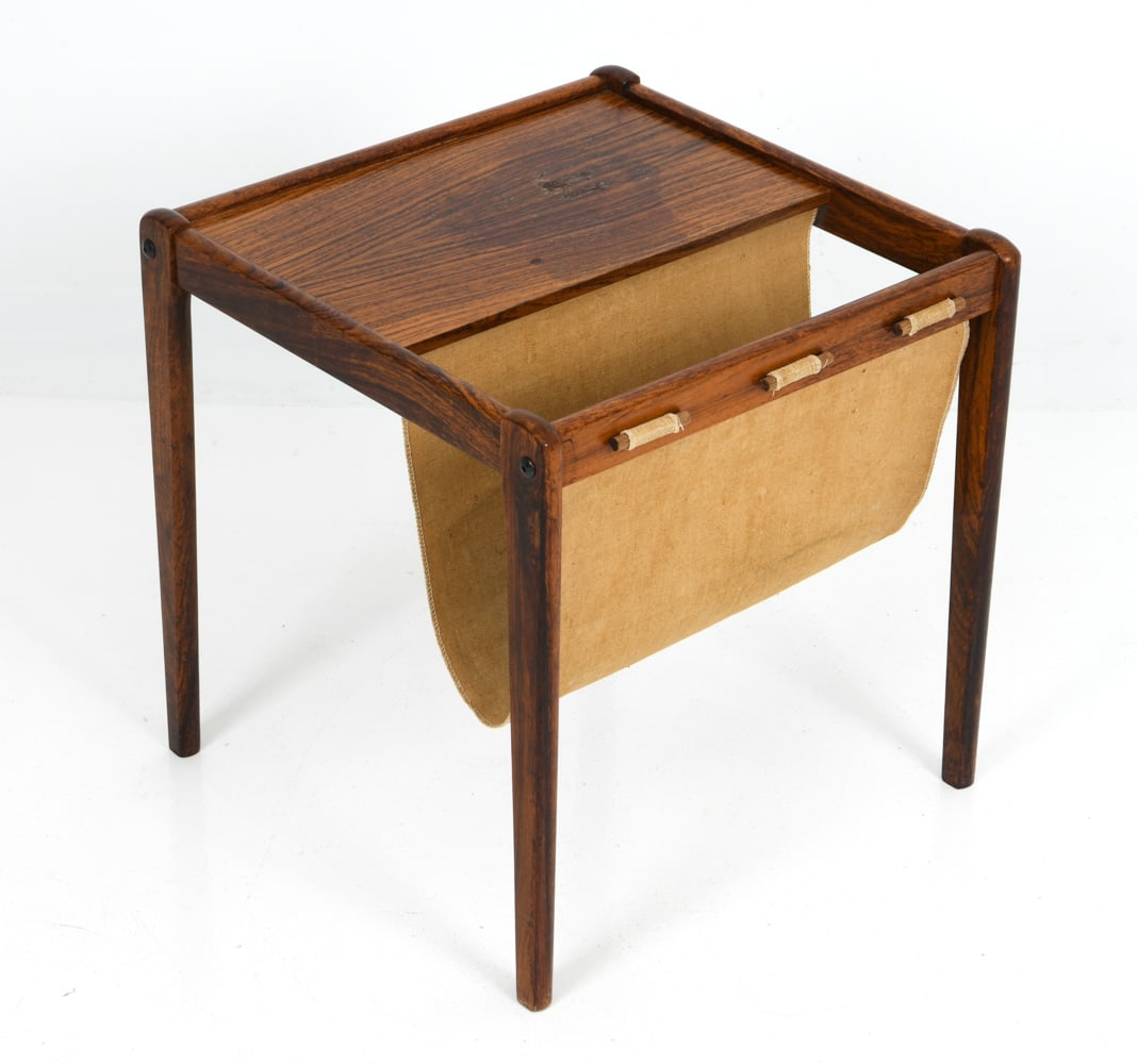 BRDR. FURBO DANISH ROSEWOOD MAGAZINE RACK C. 1960S: Rosewood frame with canvas sling. Danish mark underneath. Denmark, circa 1960s. Dimensions: H 18" x W 17.75" x D 17.5" Condition: Wear consistent with age and use. Discoloration to top and sling.