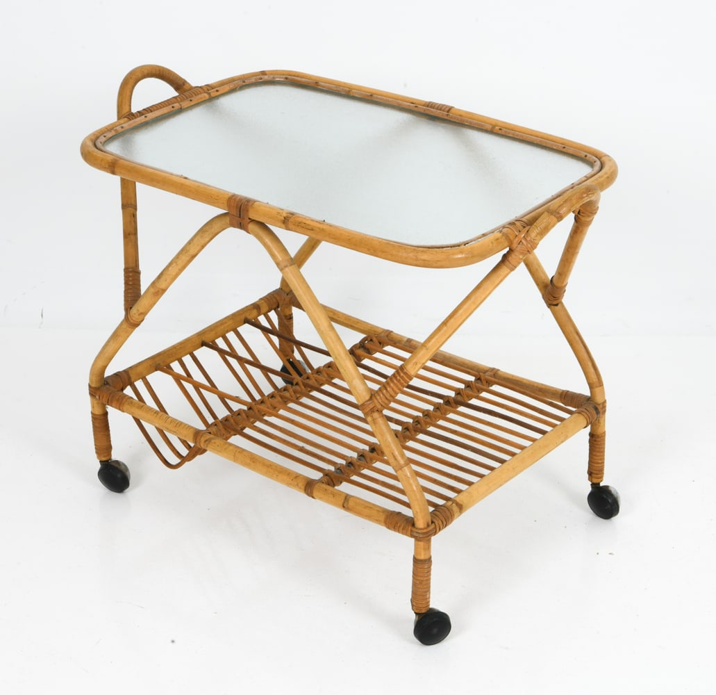 ITALIAN BAMBOO & GLASS BAR CART C. 1960S: Bamboo and rattan frame bar cart on casters with textured glass top and lower slatted shelf. Italy, circa 1960s. Dimensions: H 23" x W 30.25" x D 17.5" Condition: Wear consistent with age and use. Sur