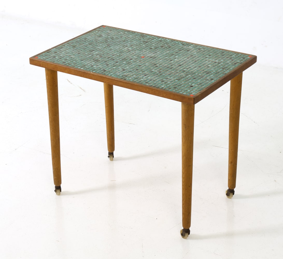 SCANDINAVIAN TEAK & TILE SIDE TABLE C. 1970S: Occasional table with inlaid ceramic tile top on slender legs fitted with casters. Scandinavian, circa 1970s. Dimensions: H 21.5" x W 25.25" x D 16.5" Condition: Few paint marks to top, Wear consisten