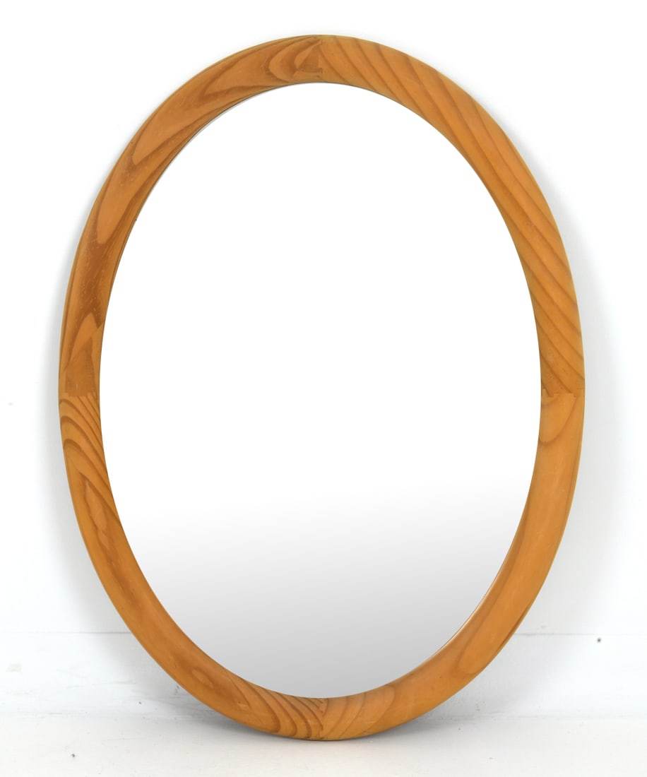 MID-CENTURY SCANDINAVIAN PINE OVAL MIRROR: Oval form mirror with pine frame, apparently unmarked. Dimensions: H 31.5" x W 23.5" Condition: Wear consistent with age and use including scuffs and rubs.