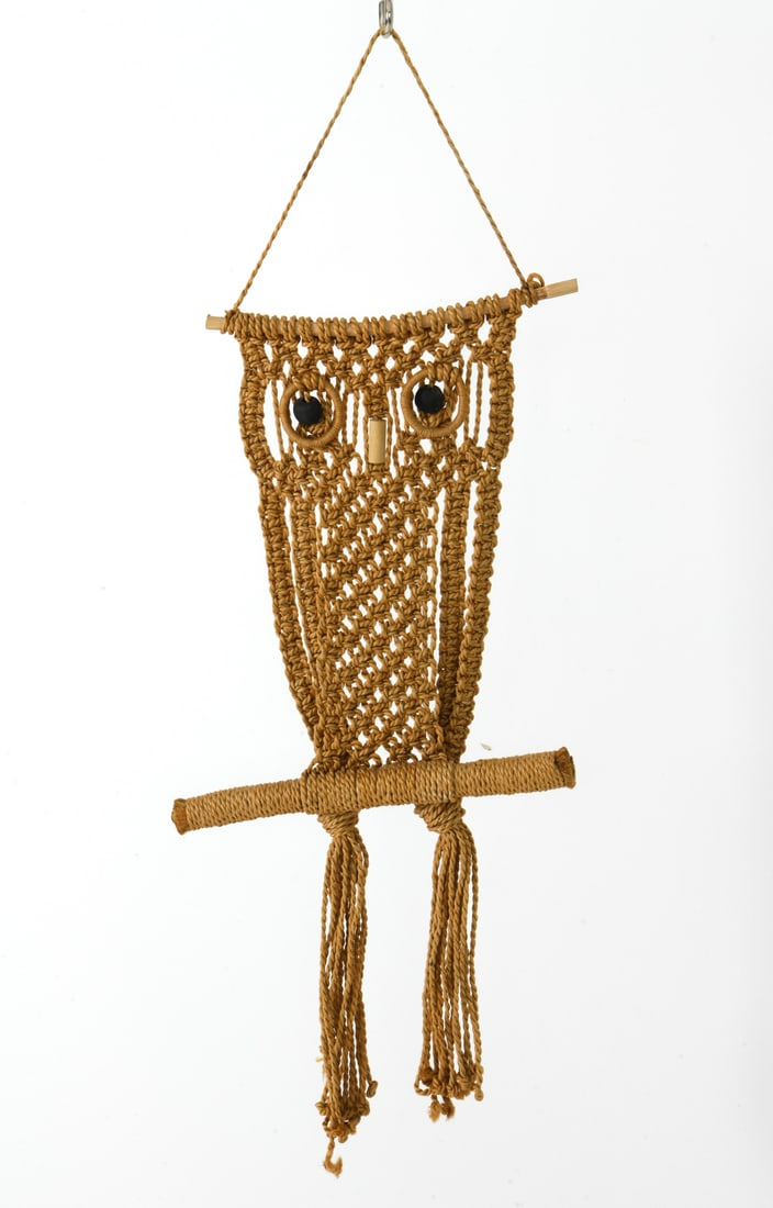 VINTAGE WALL HANGING ROPE MACRAME OWL: Wall art in the form of an owl made with woven and wrapped jute rope and beads for the eyes. Dimensions: H 28" x W 10.5" x D 1.75" Conditions: Wear consistent with age and use including spots of frayi