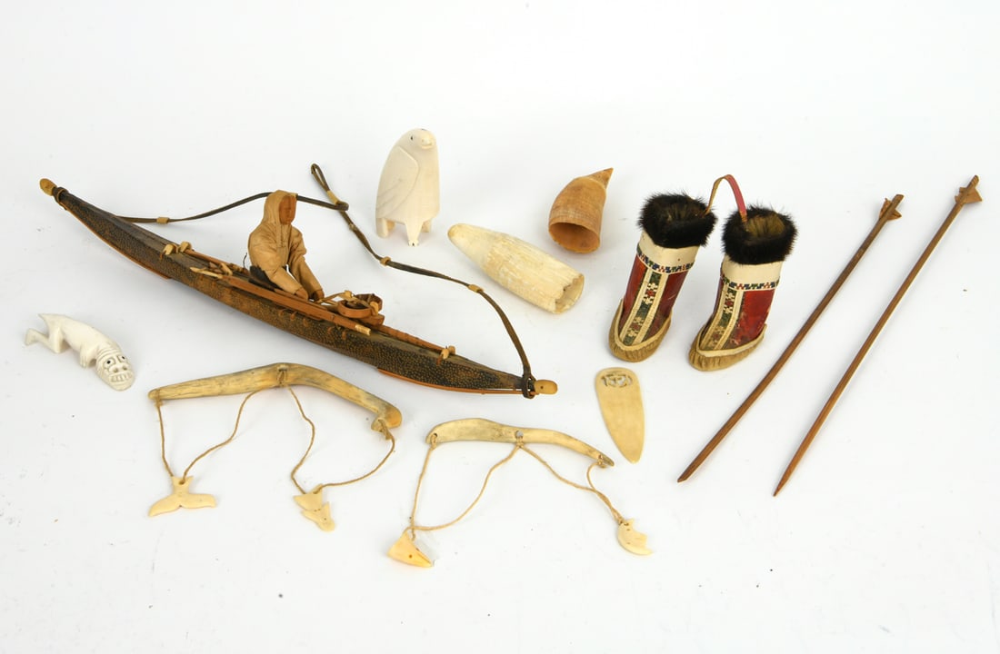 GREENLANDIC INUIT GROUPING: Grouping includes a model of a kayak, figures, carvings, arrows and others. Dimensions: (Boat) H 4" x W 19.75" x D 2" Condition: Wear consistent with age and use including age toning, small losses, po