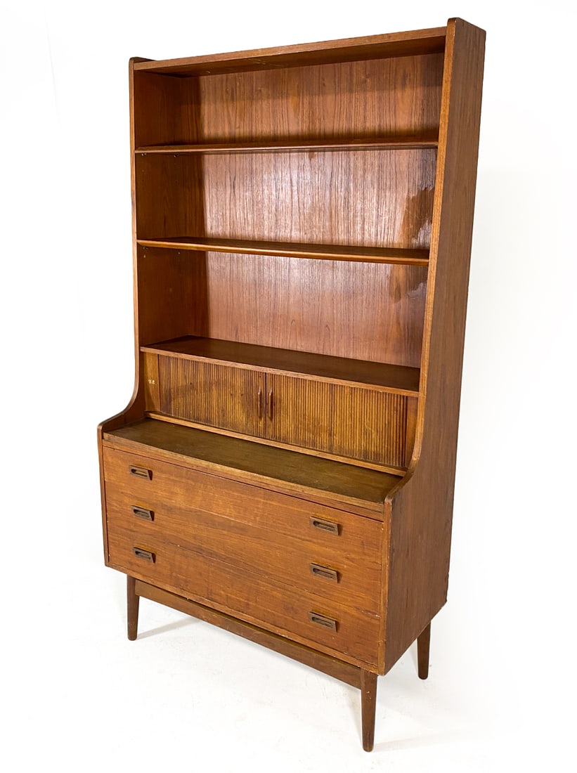 JOHANNES SORTH DANISH TEAK CABINET C. 1960S: For Nexo Mobelfabrik. Adjustable shelves. Tambour cabinet doors to center shelf. Sits freely on base. Brass letters 'V.A.' to panel near tambour cabinet. Apparently unmarked. Denmark, circa 1960s. Dim