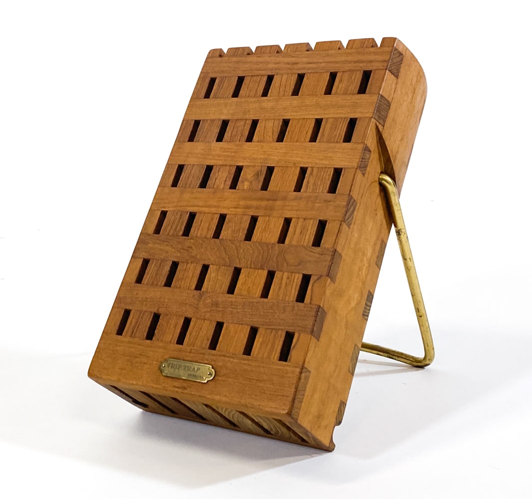 TRIP TRAP DANISH TEAK KNIFE BLOCK C. 1970S: Teak knife block with brass stand. Denmark, circa 1970s. Dimensions: H 11.25" x W 7" x D 3.5". Condition: Minor scuffs, wear consistent with age and use. Clev 25