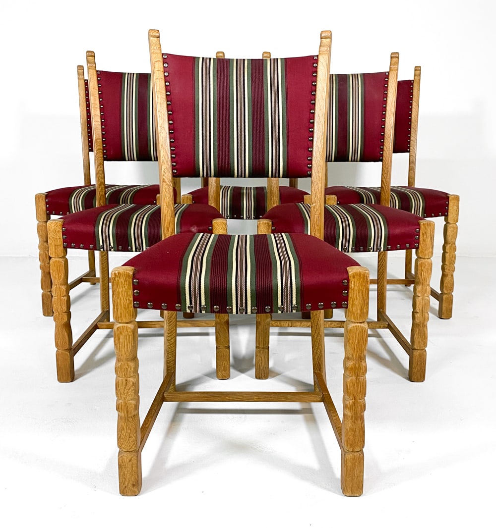 (6) STYLE OF KJAERNULF DANISH DINING CHAIRS 1970S: Oak frames with turned legs. Striped upholstery with brass tacks accents. Denmark, circa 1970s. Dimensions: H 36" x W 16.25" x D 17.25" x SH 17". Condition: Scuffs and dings to wood, wear consistent w