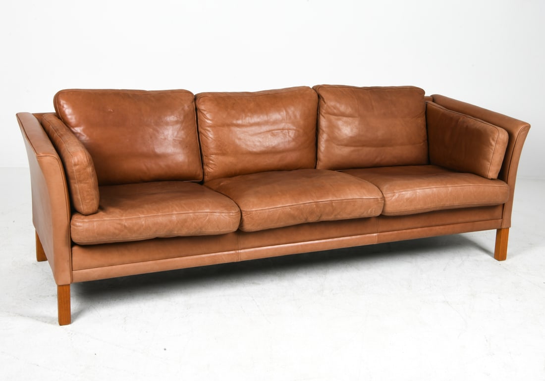 MOGENS HANSEN DANISH LEATHER SOFA C. 1960S: Cognac leather sofa with beech legs. Apparently unmarked. Denmark, circa 1960s. Dimensions: H 27" x W 83" x D 28" x SH 15". Condition: Minor scuffs and rubs to leather, wear consistent with age and us
