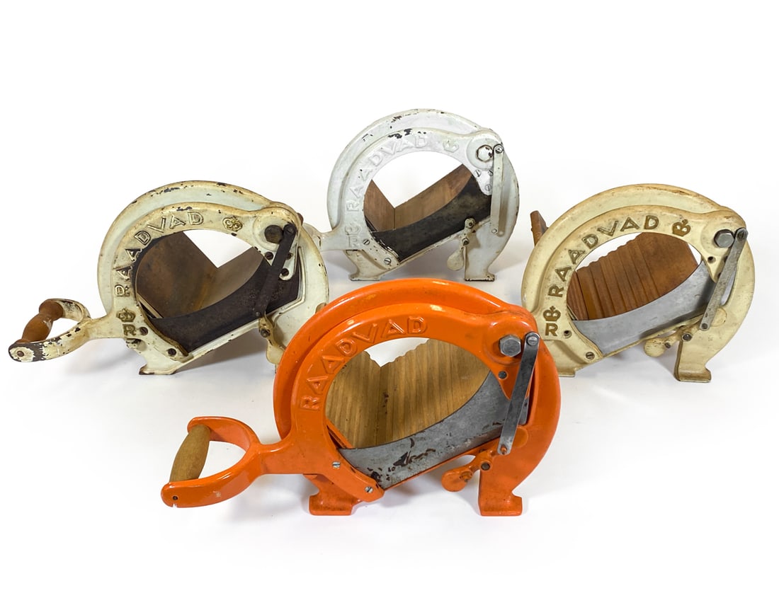 (4) RAADVAD DANISH BREAD SLICERS C. 1960S: Grouping of (4) cast iron bread slicers with wooden trays. Marked to metal. Denmark, circa 1960s. Dimension:(Biggest) H 9.25" x W 13.75" x D 9". Condition: Wear consistent with age and use including m