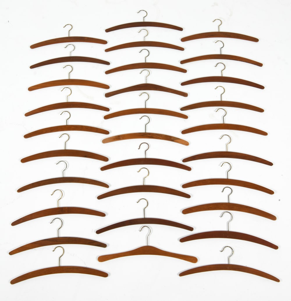 DANISH TEAK COAT HANGERS C. 1960S: (30) Teak hangers total. Dimension: H 5.75" x W 17.5" Condition: Wear consistent with age and use DA_21