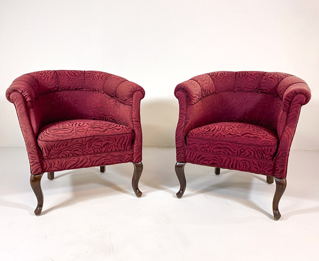 PAIR OF SCANDINAVIAN ANIMAL PRINT LOUNGE CHAIRS: Pair of lounge chairs in pink and red zebra print fabric upholstery. Carved beech legs. Scandinavian, circa 1960s. Dimensions: H 29" x W 31" x D 26" x SH 17.5". Condition: Scratches and dings to legs.