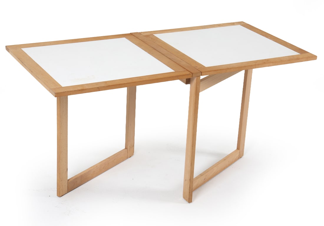 ARNE ROBBERT FOLDING BEECH SIDE TABLE C. 1980S: Beech frame with white laminate top. Can fold entirely down for storage needs. Denmark, circa 1980s. Dimensions: As Shown H 20.5" x W 41" x D 19.5". Condition: Faint water ring to top, scuffs and rubs