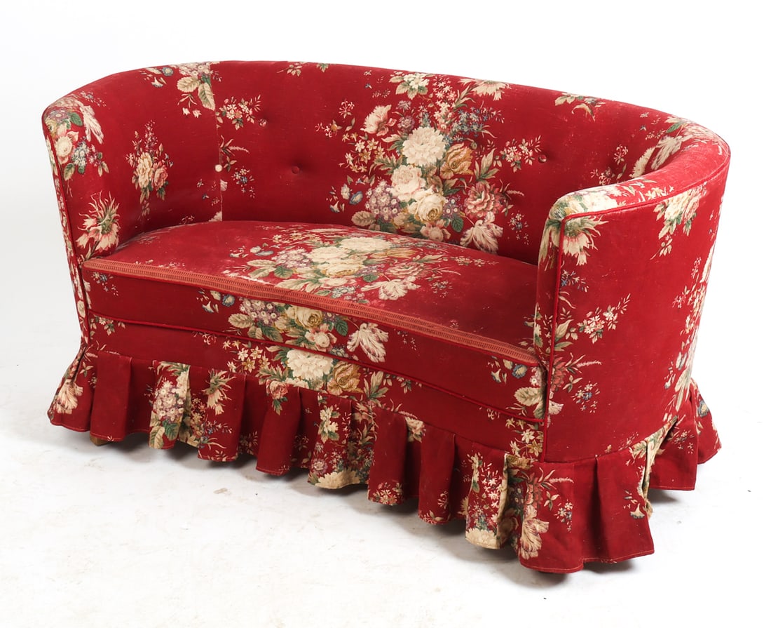 DANISH FLORAL BANANA SOFA C. 1960S: Banana sofa in red with floral patterned upholstery. Denmark, circa 1960s. Dimensions: H 25.75" x W 49.5" x D 23" x Sh 15.5". Condition: Wear consistent with age and use including minor sun-fading to