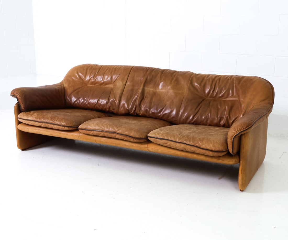 DE SEDE DS-16 SWISS LEATHER SOFA C. 1970S: Features a three-seat sofa upholstered in leather. Tufted backrest and armrest with seat cushions and stitching details. Apparently unmarked. Swiss, circa 1970s. Dimensions: H 28" x W 81.5" x D 34" x