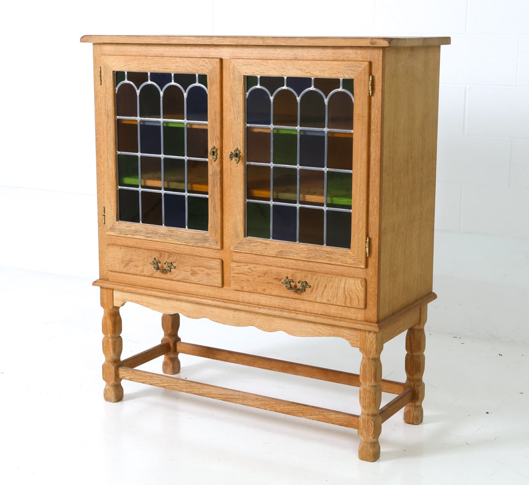 HUNDSTRUP DANISH OAK & GLASS CABINET C. 1960S: Two keys included. Danish cabinet in carved oak with tinged glass doors and drawers. Stamped to back. Denmark, circa 1960s. Dimensions: H 48" x W 42" x D 17.5" Condition: Wear consistent with age and