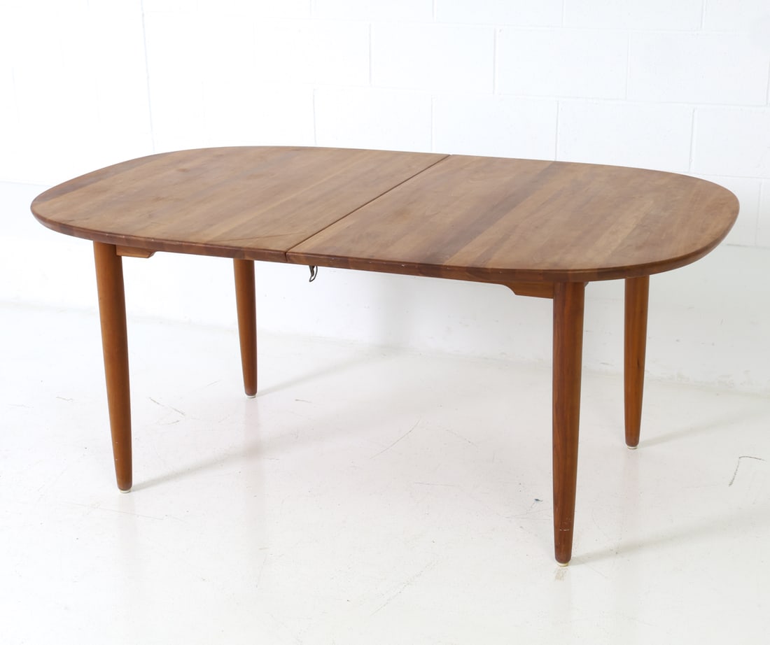 RUBBY DANISH WALNUT EXTENDING DINING TABLE: Two leaves included. Stamped under table edge. Denmark, circa 1990s. Dimensions: H 29" x W 65" x D 40.5" (Each leaf) W 19" Condition: Wear consistent with age and use. Scratches, marks, light soiling