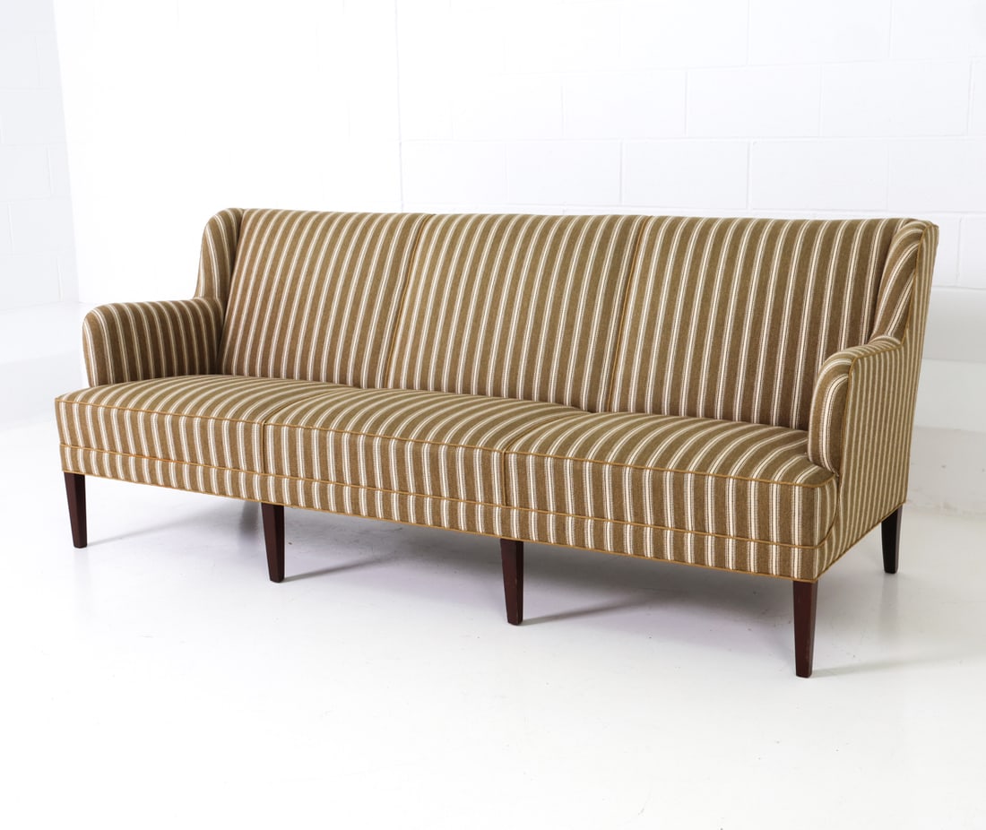 ATTR. FRITS HENNINGSEN DANISH BEECH SOFA C. 1960S: Three-seater sofa with armrests and beech legs. Piping details to edge. Denmark, circa 1960s. Dimensions: H 33" x W 81" x D 30" x SH 16" Condition: Wear consistent with age and use. Nicks and scuffs t