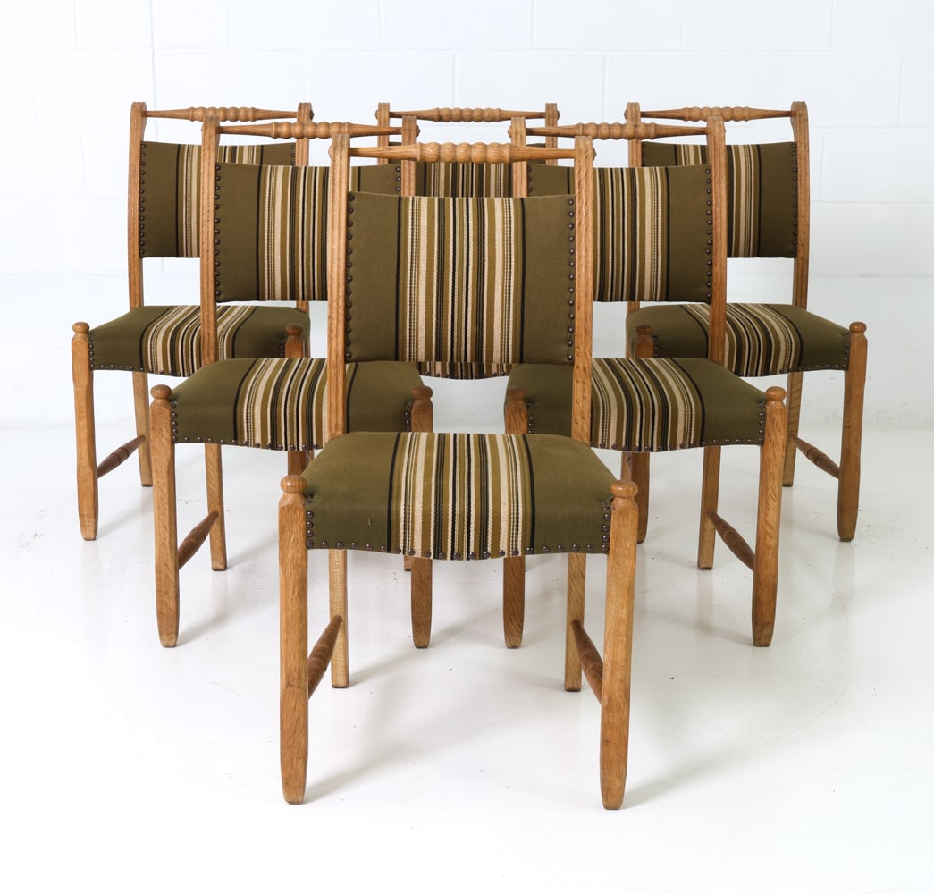 (6) KJAERNULF STYLE DANISH OAK DINING CHAIRS 1960S: Oak frame. Curved backrest with carved top rail and turned legs. Striped pattern upholstery. Denmark, circa 1960s. Dimensions: H 35.75" x W 19" x D 20.5" x Sh 18" Condition: Minor rubs and scuffs to w