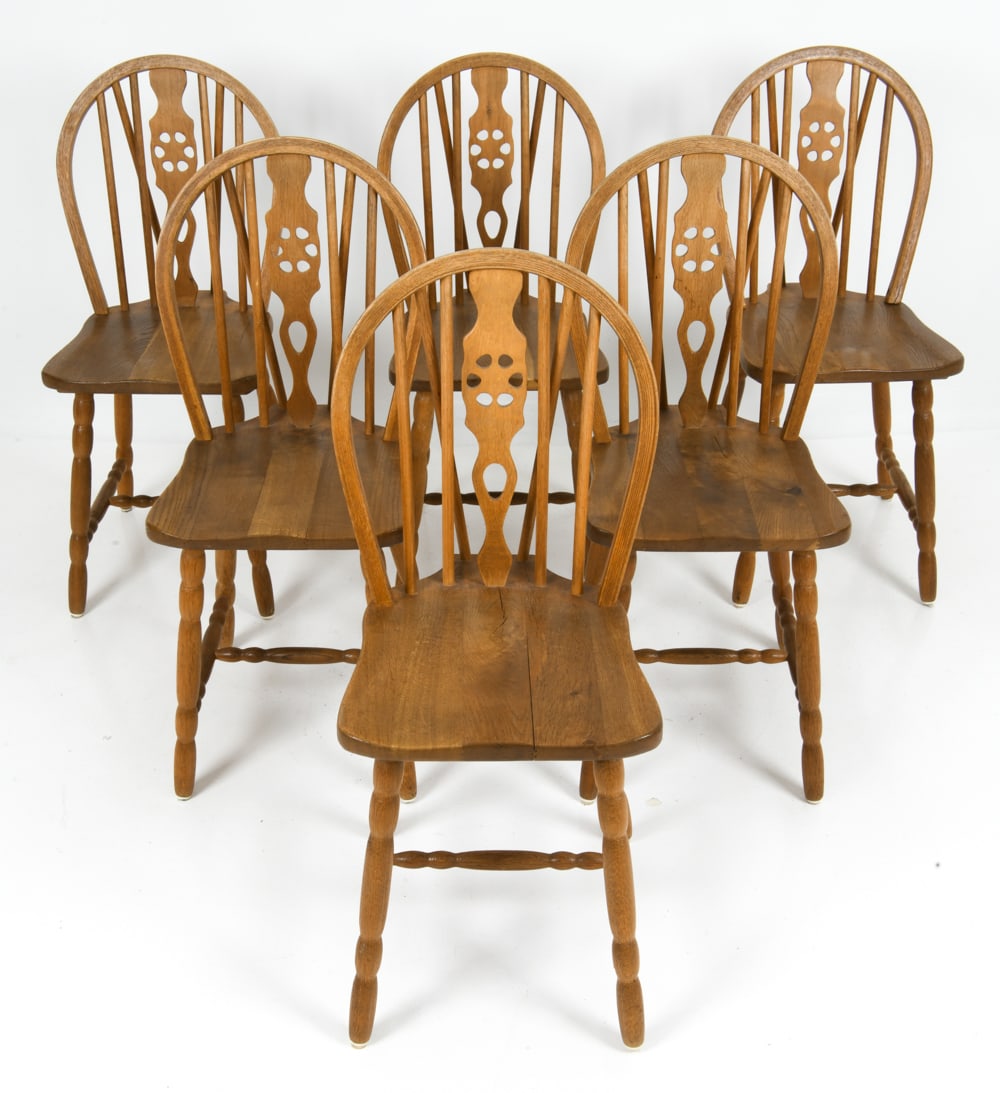 (6) SCANDINAVIAN OAK DINING CHAIRS C. 1960S: Oak frame with wheel back and turned legs. Vertical spindles and carved central splat. Scandinavian, circa 1960s. Dimensions: H 35.5" x W 14.5" x D 20" x SH 19" Condition: Minor rubs and scuffs to fra
