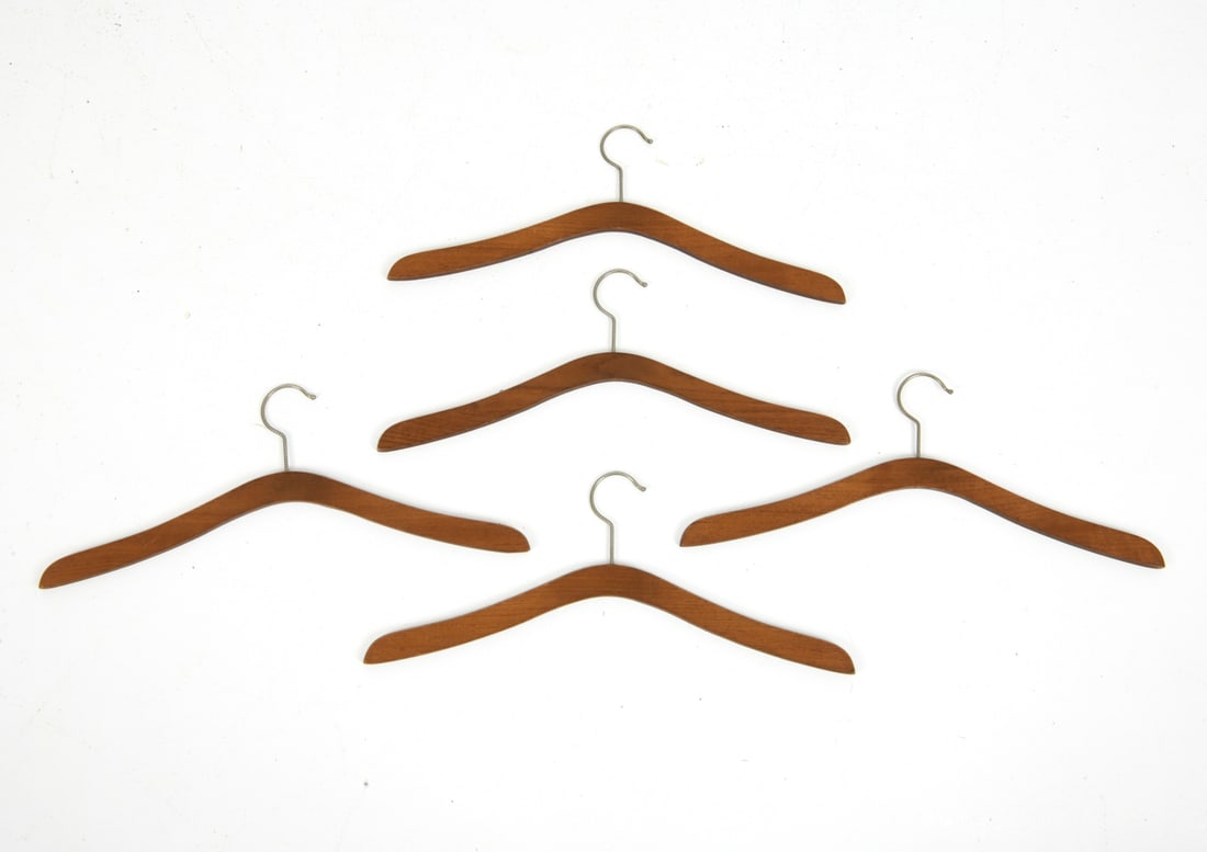 VINTAGE DANISH TEAK COAT HANGERS: Grouping of (5) teak coat hangers with brass hooks. Dimensions: H 7.25" x W 17.5" Condition: Wear consistent with age and use including light surface wear.