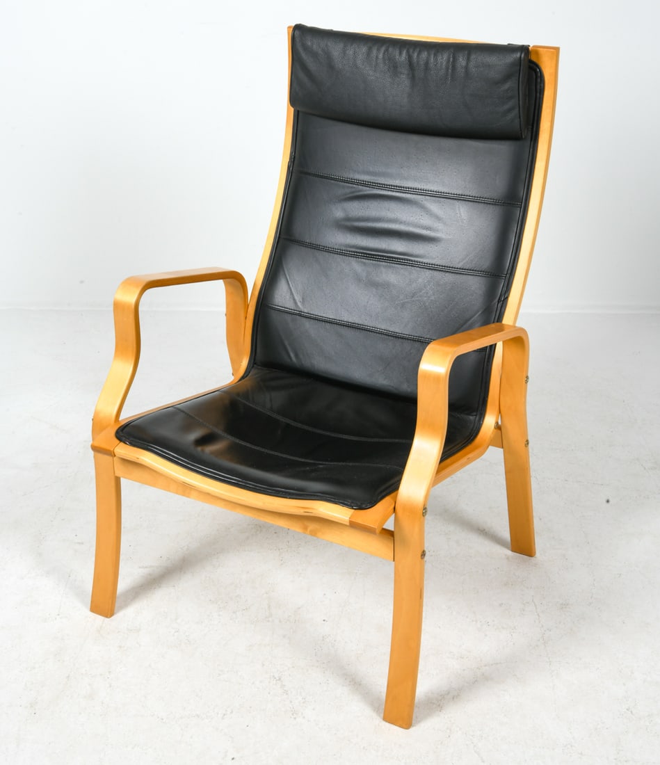 STYLE OF FINN OSTERGAARD DANISH LOUNGE CHAIR 1970S: Beech bentwood frame with black leather upholstery. Denmark, circa 1970s. Dimensions: H 40.25" x W 26.5" x D 26" x Sh 15.5". Conditions: Minor rubs and scuffs to armrest and legs, Wear consistent with