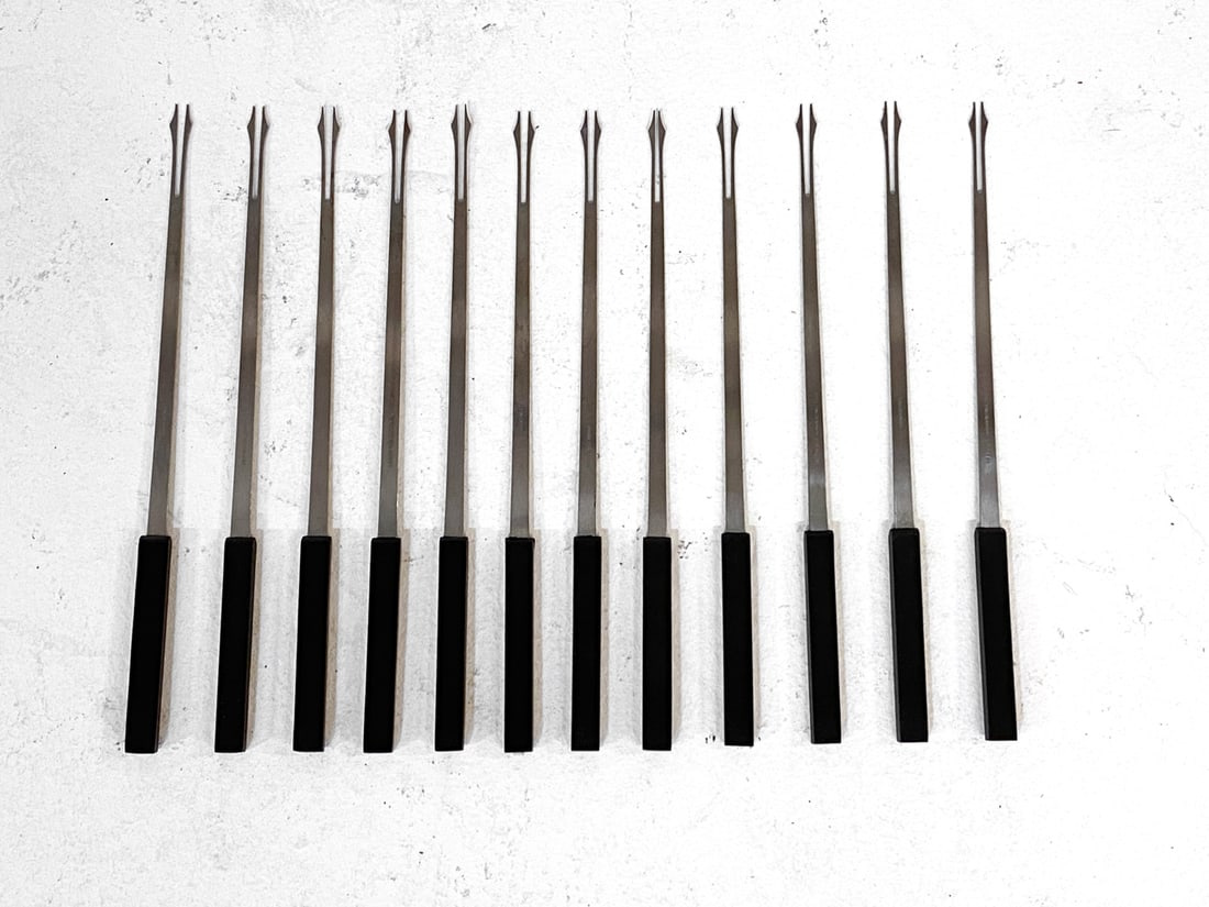 STELTON DANISH FONDUE FORKS GROUPING: (2) Boxes of Stelton fondue forks. Stainless steel with vinyl handles. Denmark, circa 1970s. Dimensions: Boxes L 12.5" x W 5.25". Condition: Some wear to edges of boxes, wear consistent with age and u
