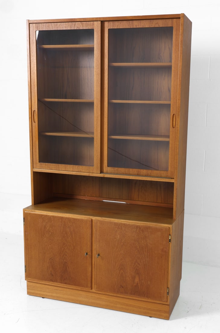 POUL HUNDEVAD DANISH TEAK CABINET 1960S: In teak, Poul Hundevad bookcase/cabinet, featuring a two-door vitrine on top and a bottom cabinet. Marked on the back. Denmark, circa 1960's. Dimensions: H 77" x W 43" x D 17" Condition: Some scratche