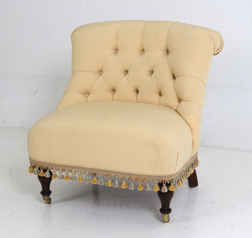 DREXEL HERITAGE SLIPPER CHAIR: Tufted slipper chair with brass casters and tassel fringe. Labeled on underside for Drexel Heritage. Dimensions: H 35" x W 32.5" x D 34" x Sh 18" Condition: Wear consistent with age and use including